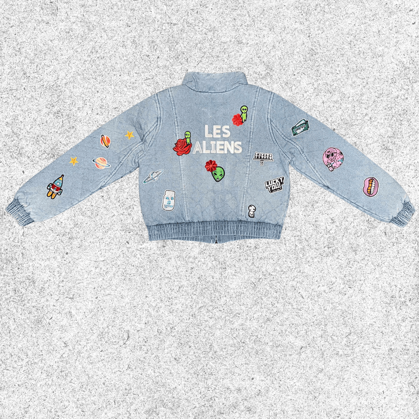 Light blue denim jacket with galactic embroidery , back view.