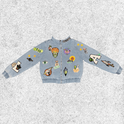 Light blue jacket with various colorful cosmic themed patches , quilted bomber front view.