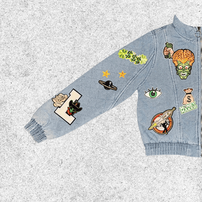Denim jacket with various patches closer view.