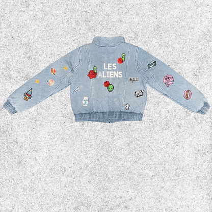 Light blue denim jacket with galactic embroidery , back view.
